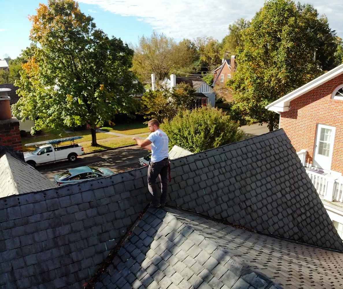 Hammersmith Roofing specialist performing a roof inspection on top of the house