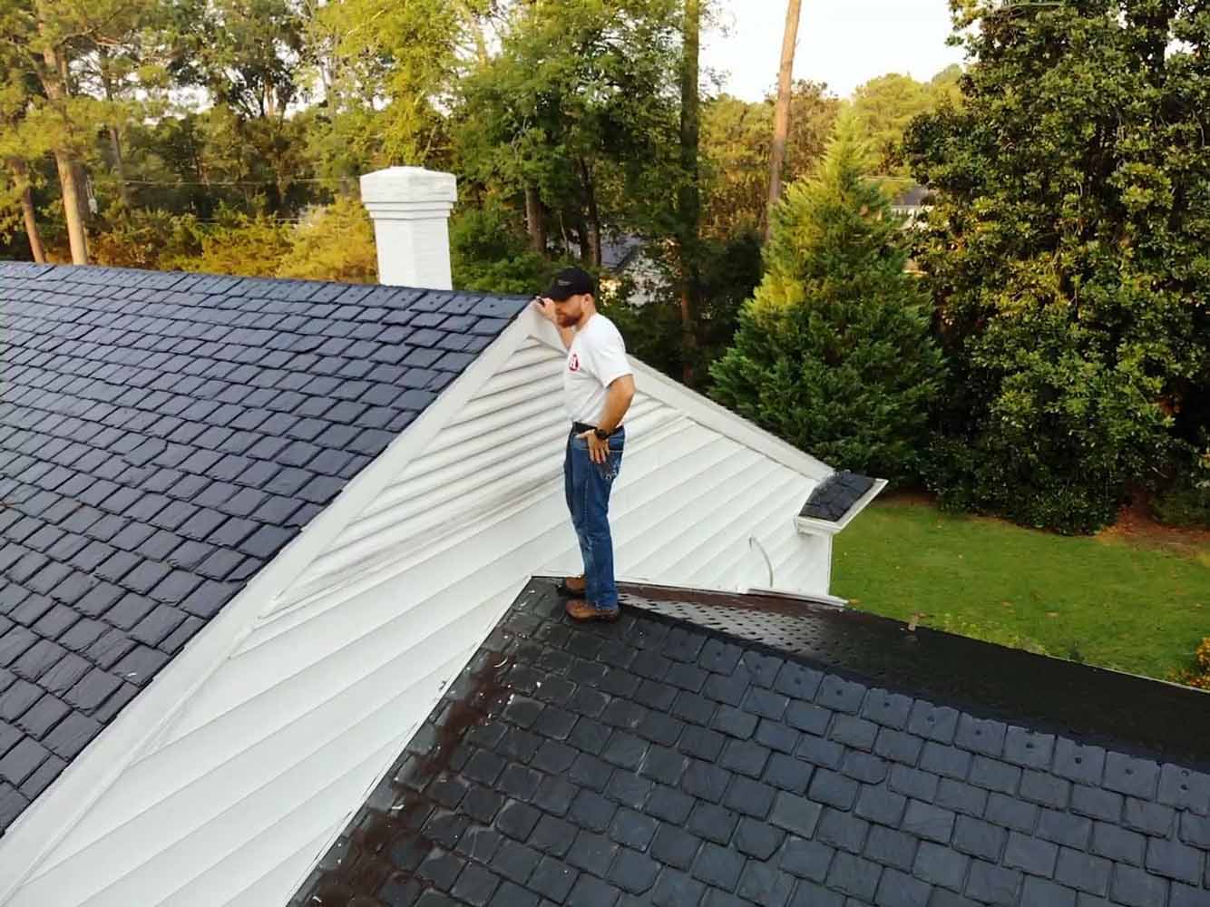 Hammersmith Roofing professional inspecting the slate roof of a client’s house