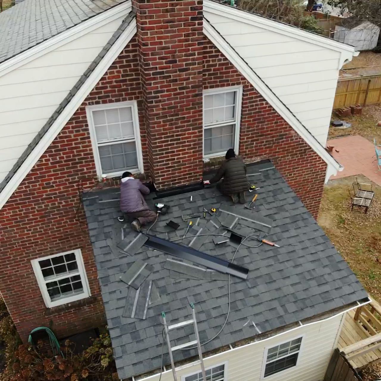 Hammersmith Roofing employees working on a roof repair in Richmond, VA