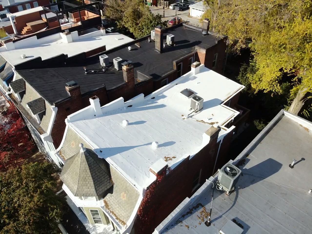 Historic Richmond, VA row homes with white and black flat roofs