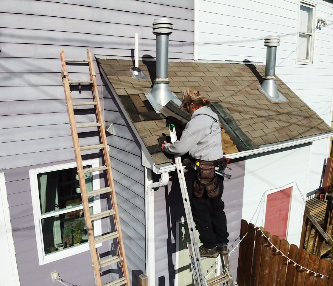 Hammersmith Roofing professional repairing some asphalt shingles after a hail storm