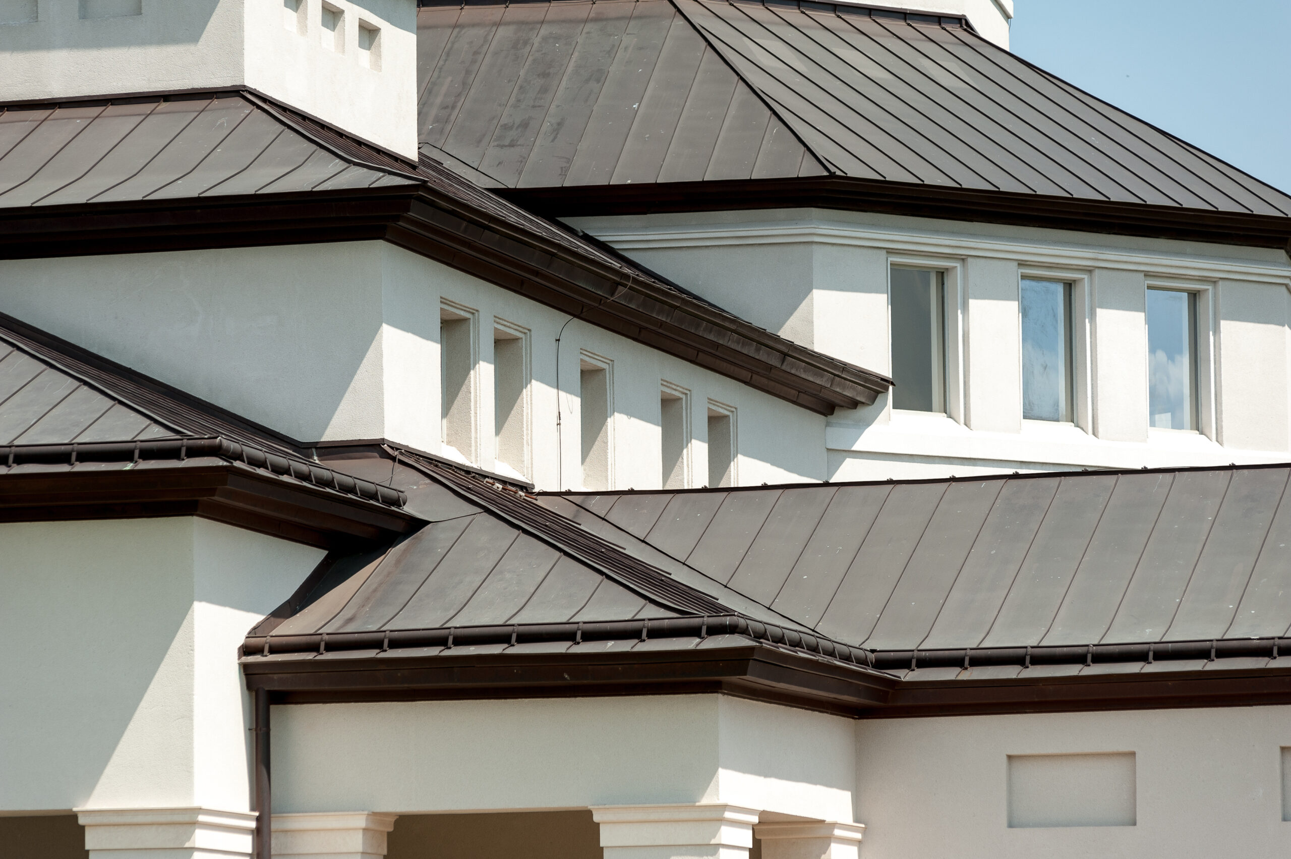 White, modern house with black metal roofing