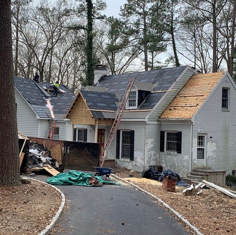 Roof replacement with old roof debris all around on the ground