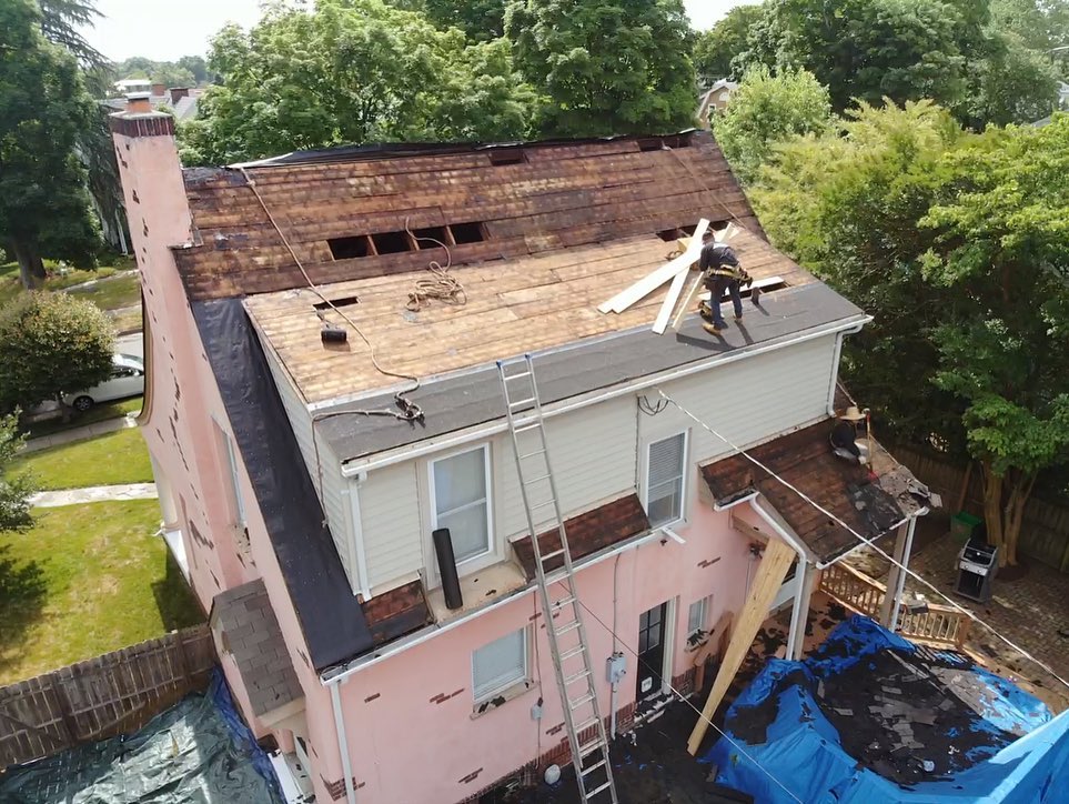 Roof replacement with old roof debris all around on the ground