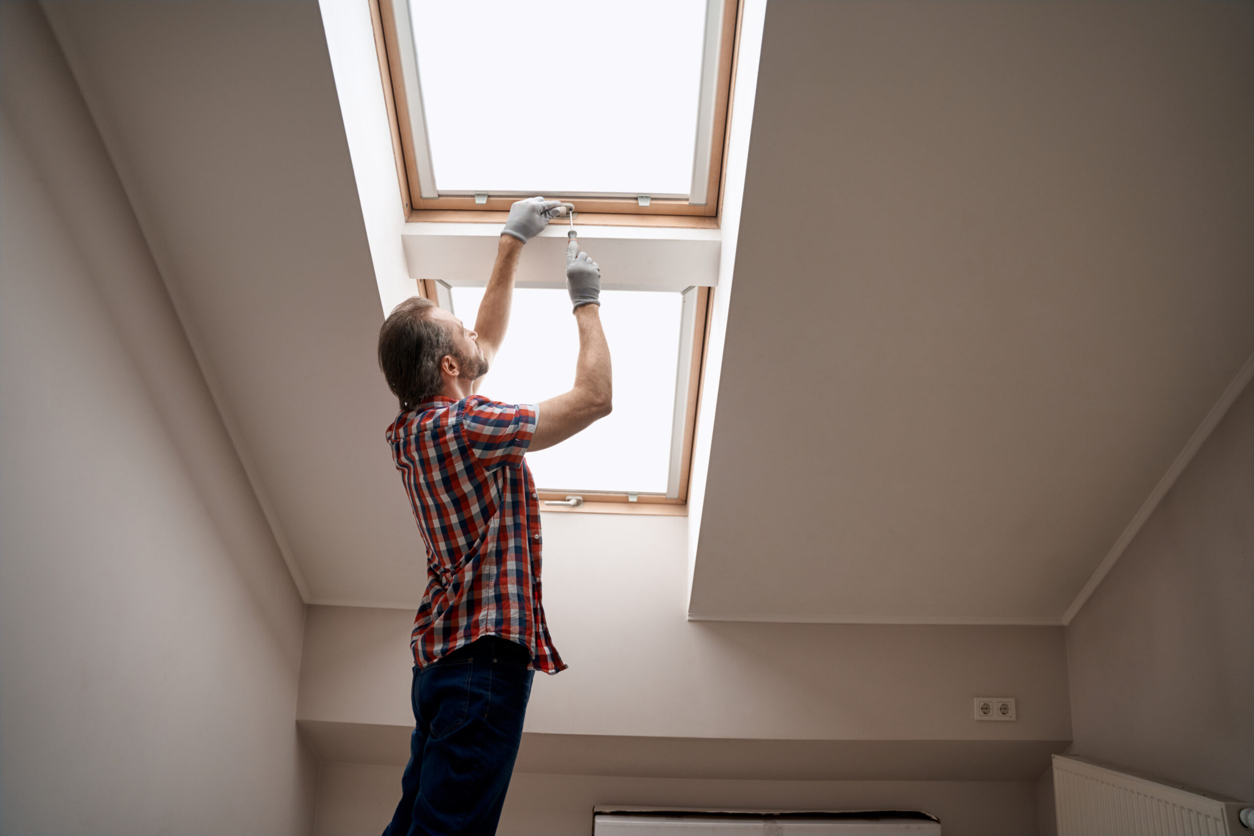 Man repairing leaking skylight