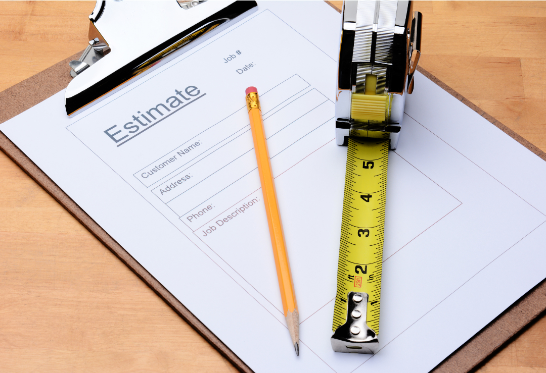 Job estimate form with a pencil and tape measure on a clipboard. 